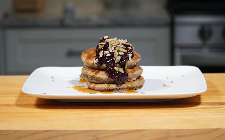 Corn Pancakes Topped with Maple Syrup and Fresh Berry Compote
